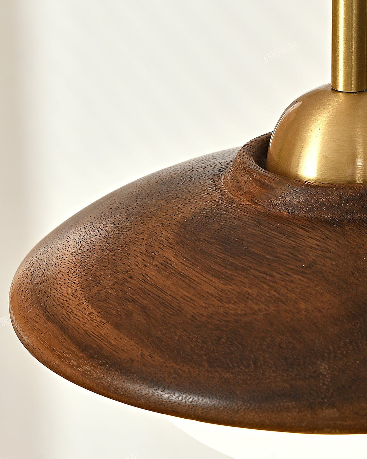 The three-globe pendant light shown against a light-colored wall.