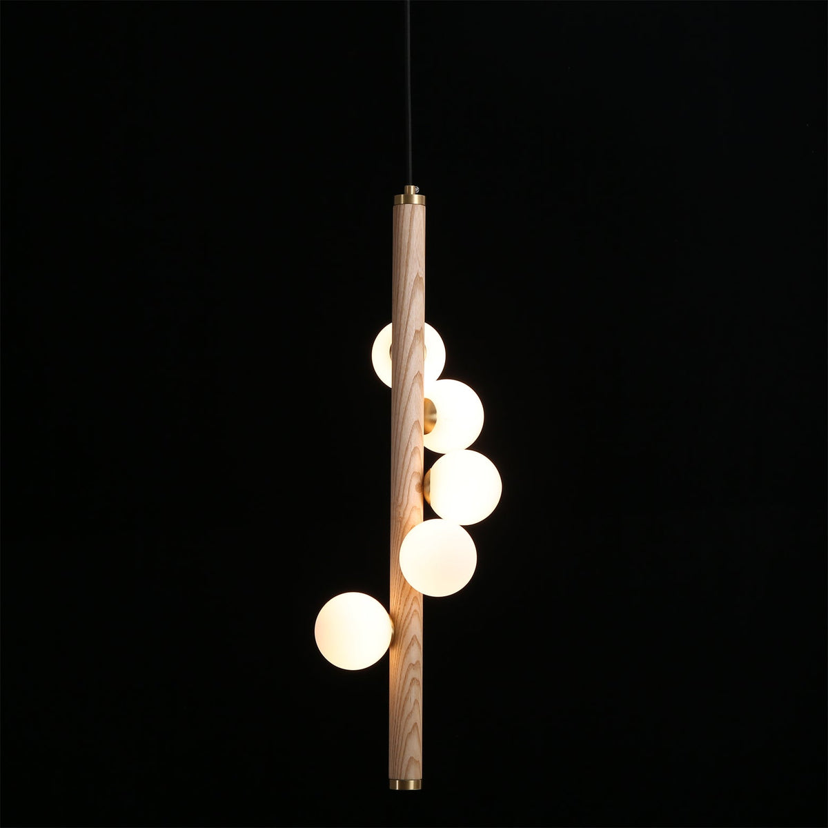 Detail of the smooth brass accents connecting the wood and glass.