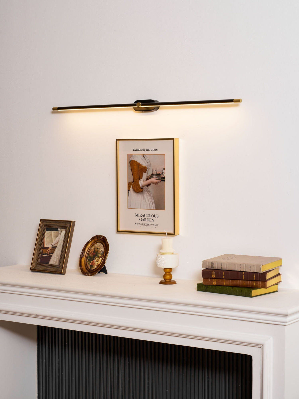 A single gold wall lamp as a statement piece in an entryway.