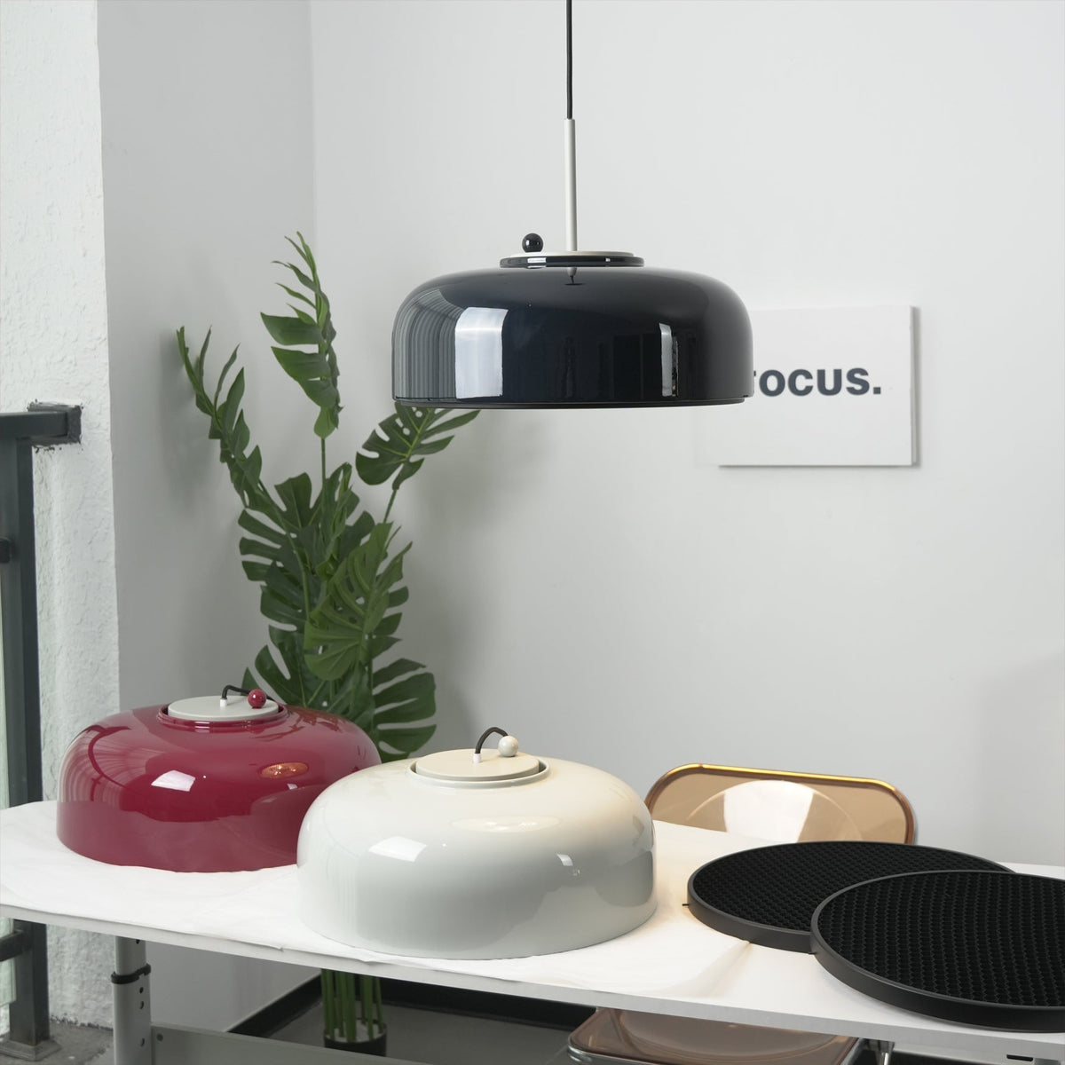 Misha Pendant Light in red against a contrasting wall.