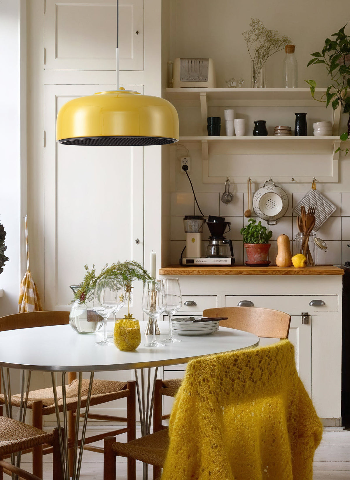 Misha Pendant Light in mustard yellow, hanging over a kitchen island.