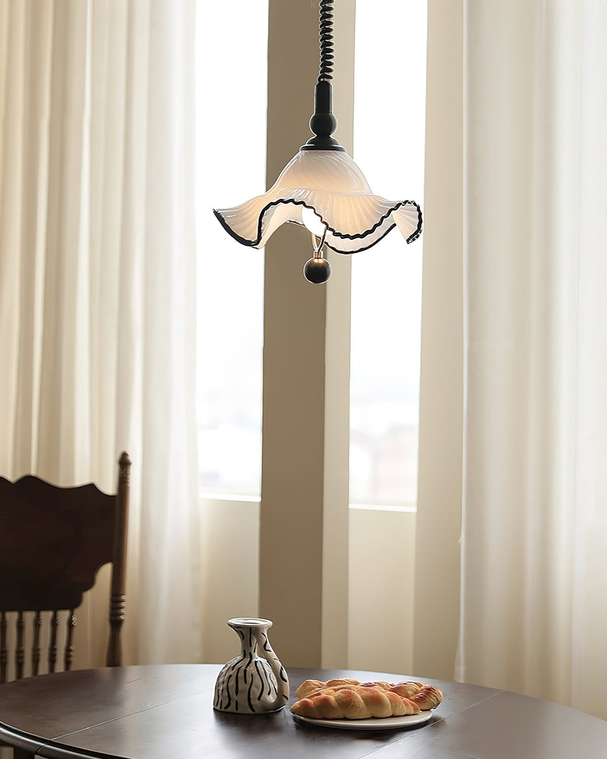 A pair of Mobo Pendant Lights hanging over a kitchen island.