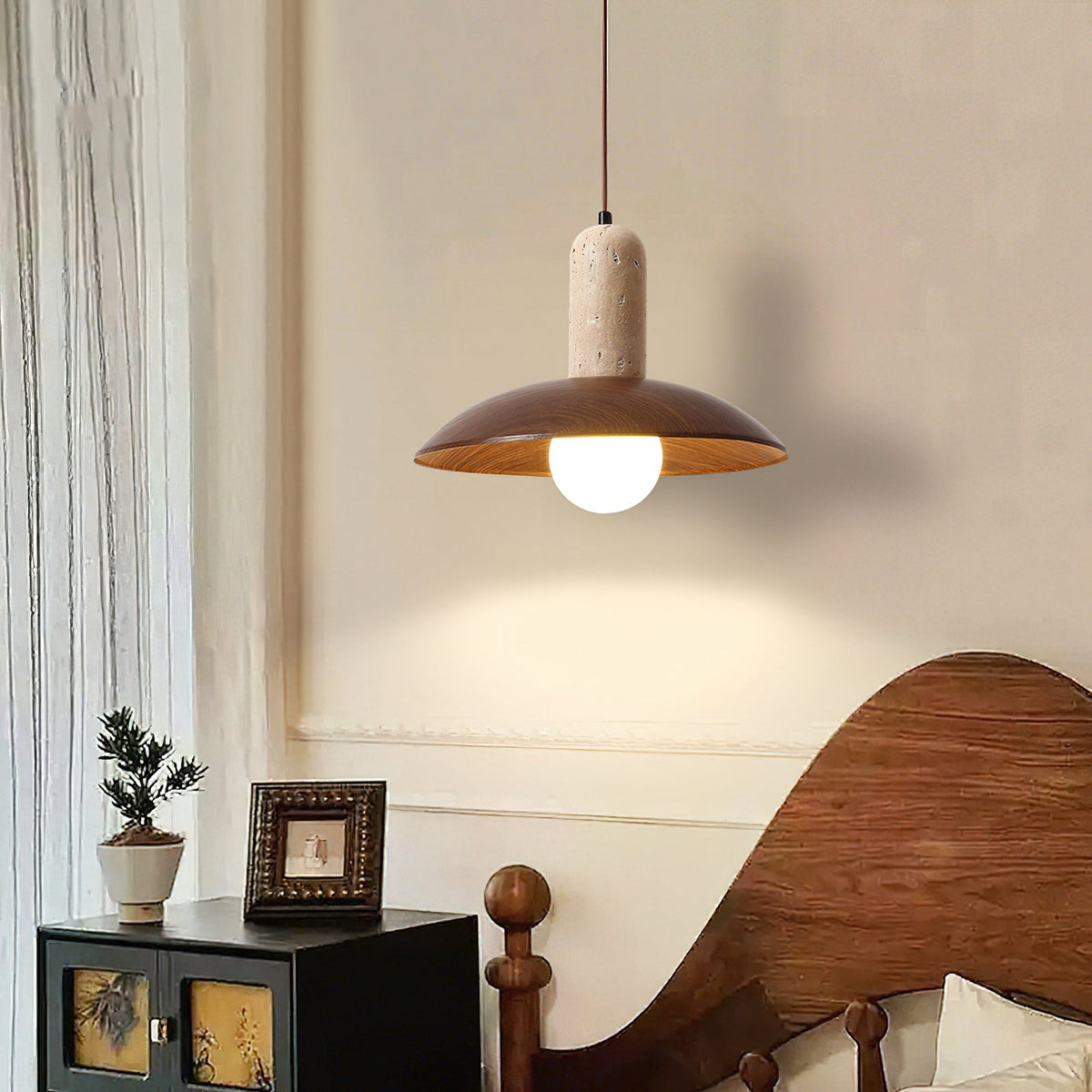 Close-up view of the Molly Pendant Lamp's textures: smooth travertine and rich wood.