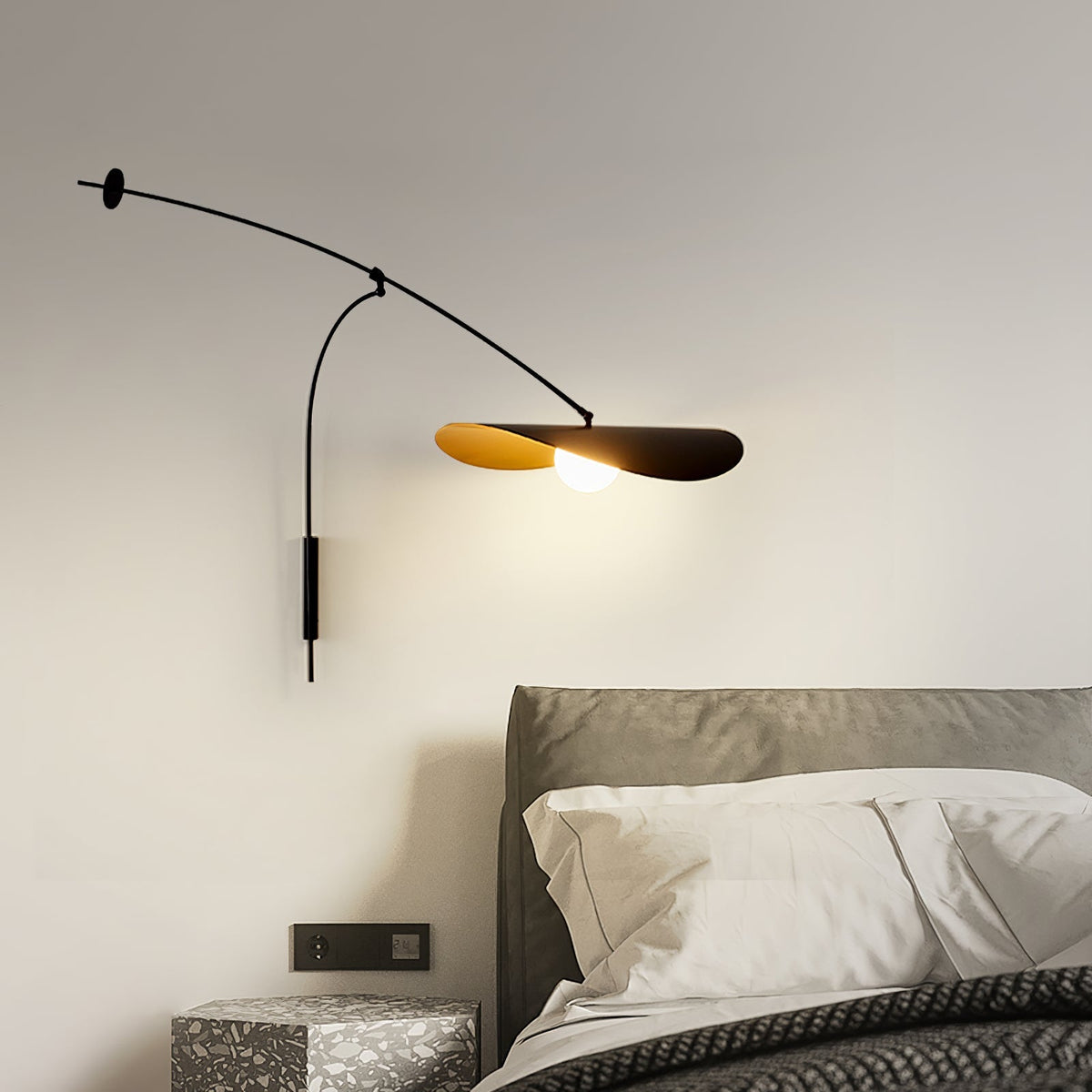 The small size Myrna Wall Lamp in a minimalist bedroom setting.