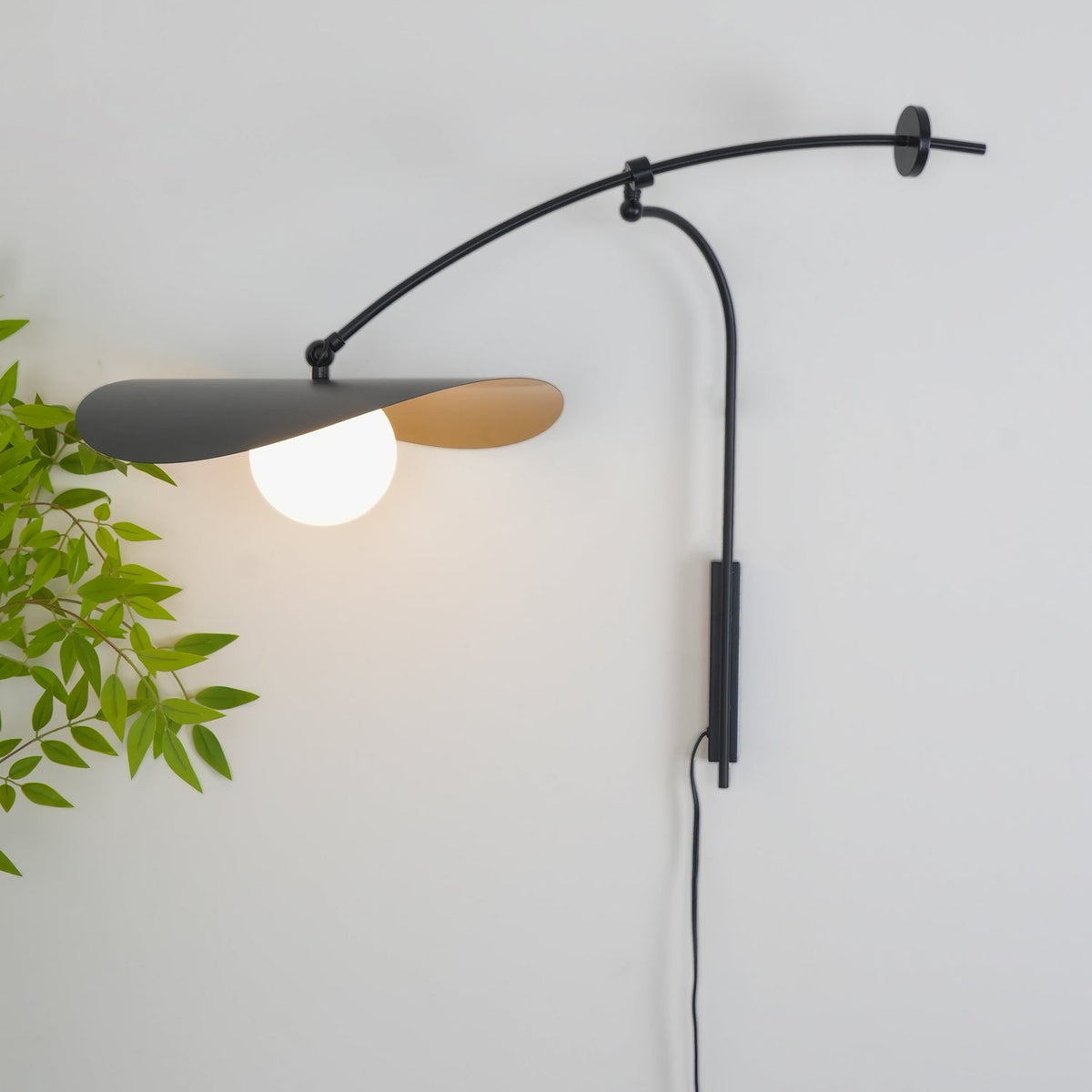 Myrna Wall Lamp shown against a dark-colored wall for contrast.