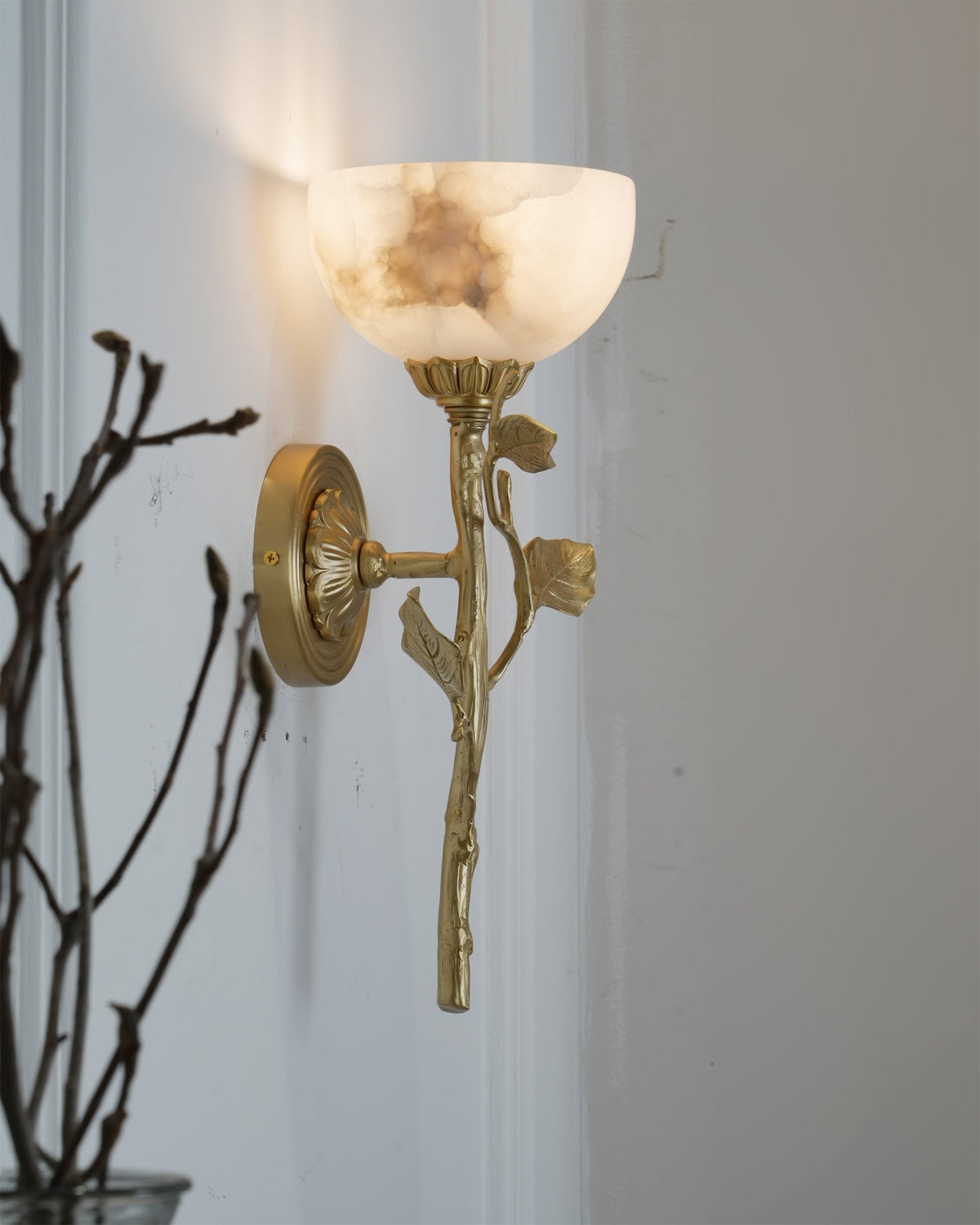 Side profile of the Natalia Wall Sconce mounted on a neutral-colored wall.