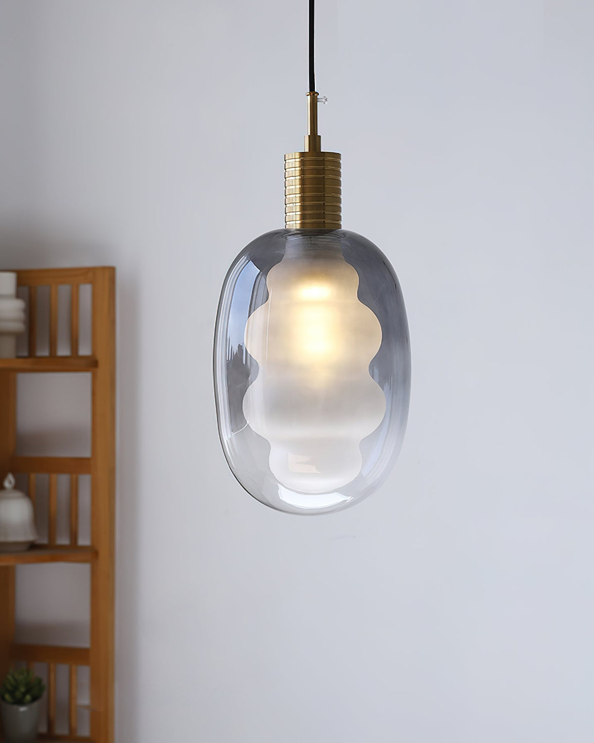 Niche Pendant Light illuminated in a dark room.