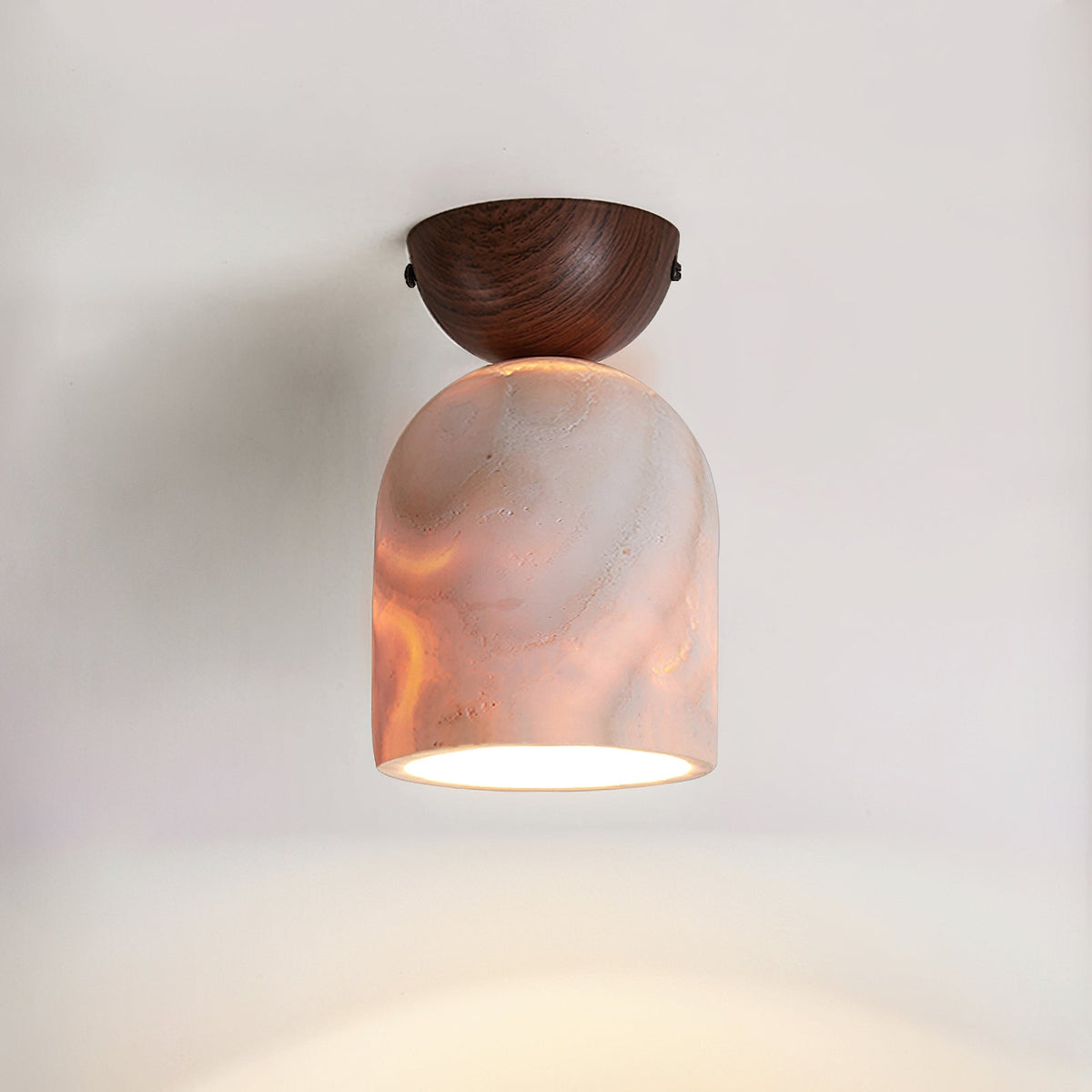 Angled view of the Noncu Travertine Ceiling Lamp with its wooden mount.