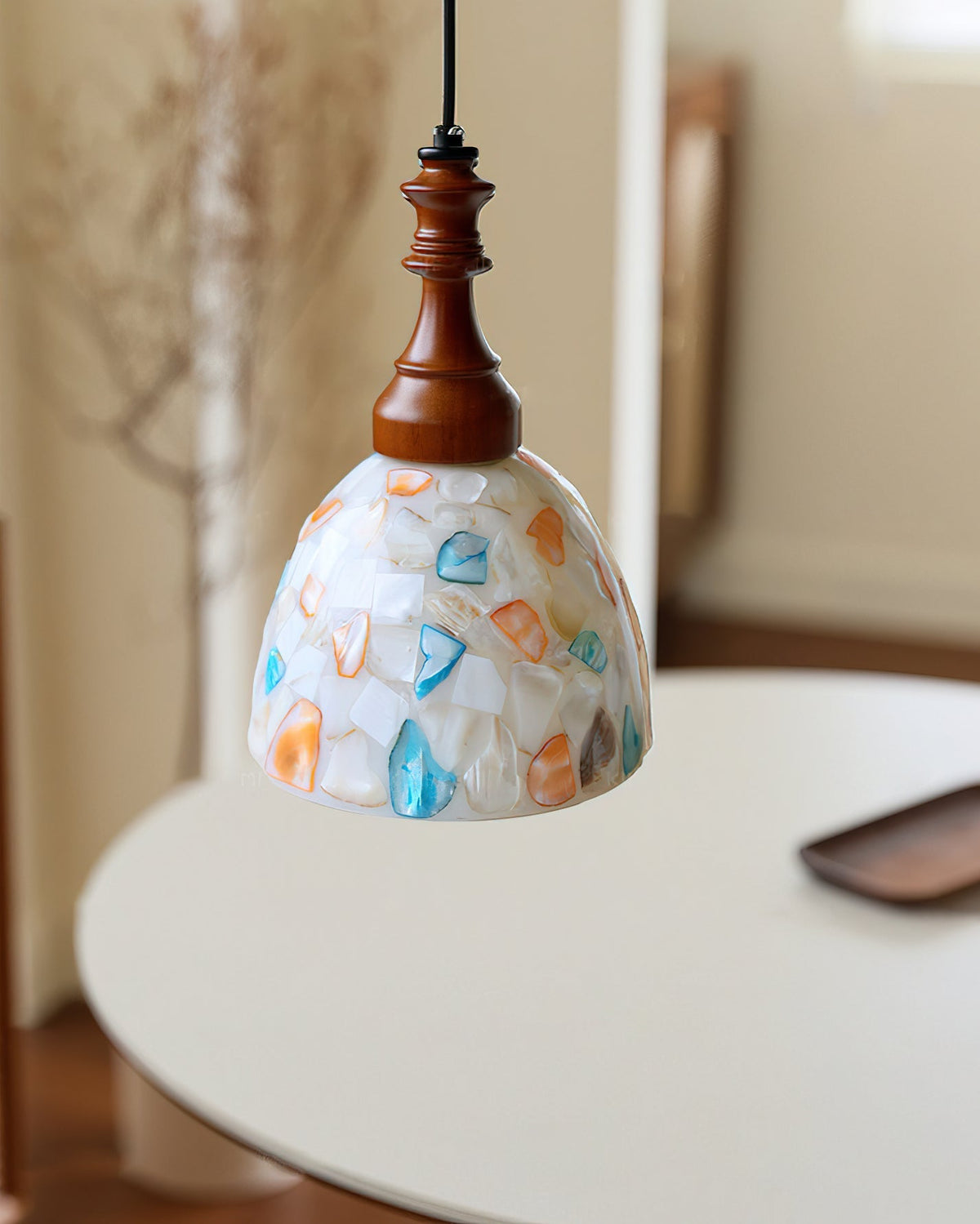 The Nonna Pendant Light illuminated, casting a warm glow.