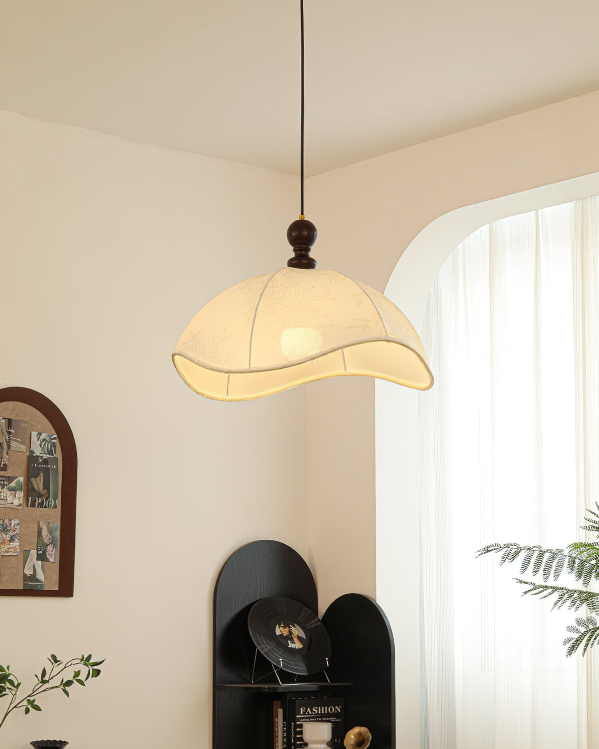 Lifestyle image of the pendant light in a serene bedroom.