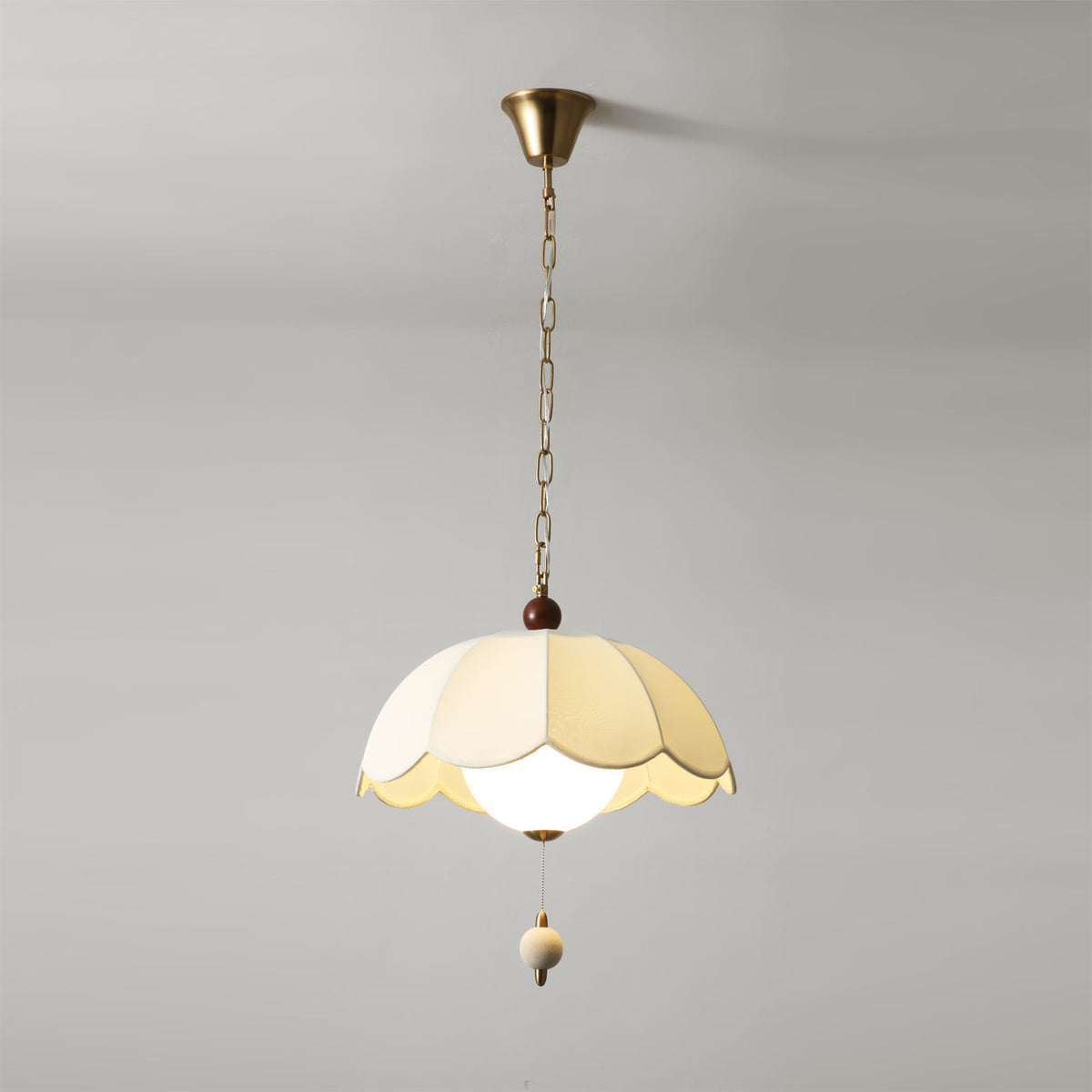 The gold hanging chain and ceiling mount of the Oriente light.