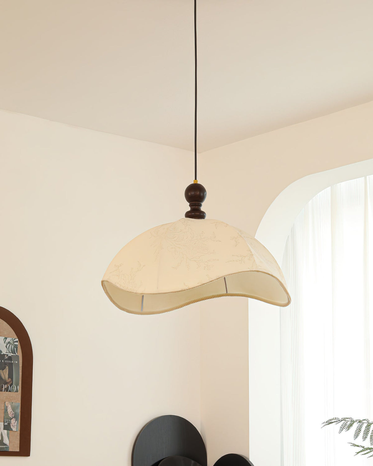 Angled view of the Oriente Pendant Light showcasing its curved silhouette.