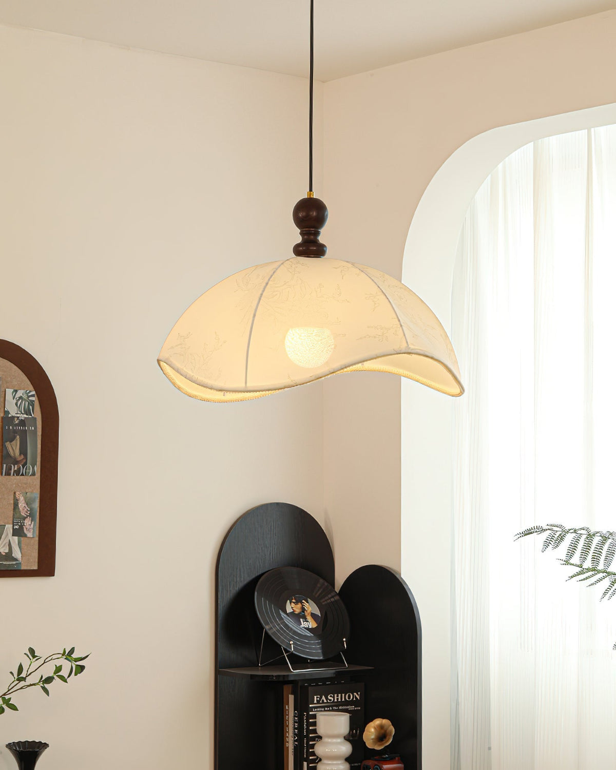 Oriente Pendant Light shown in a minimalist living room setting.