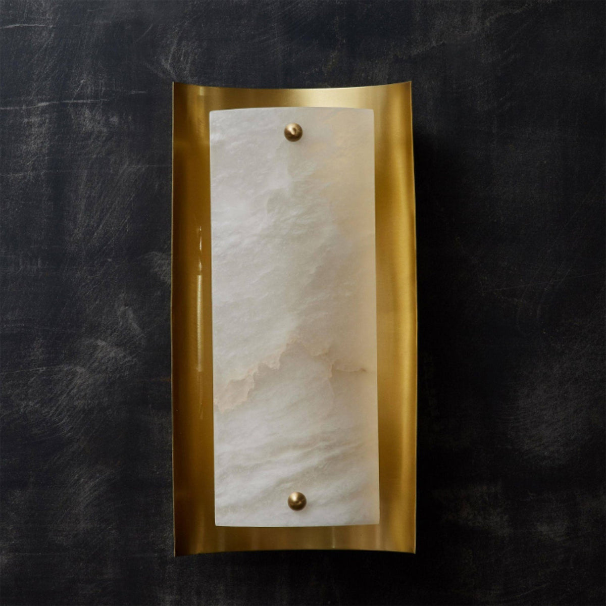 Close-up view of the Osman Wall Lamp's alabaster shade and brass fixture.