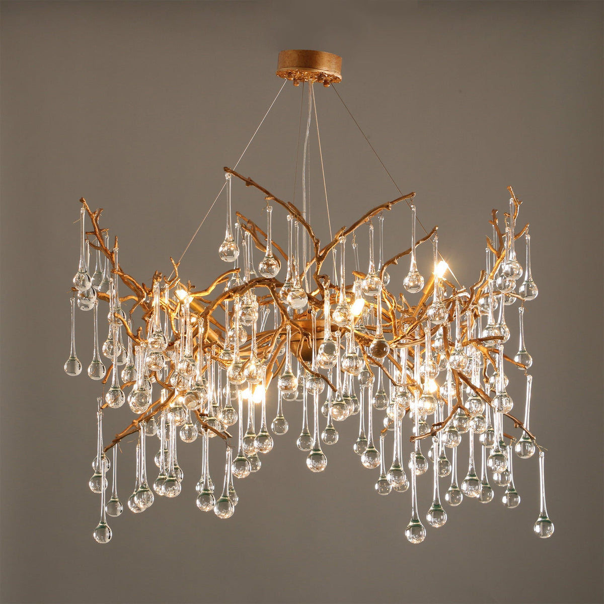 The Palwa Chandelier hanging in a modern living room, casting a warm glow.