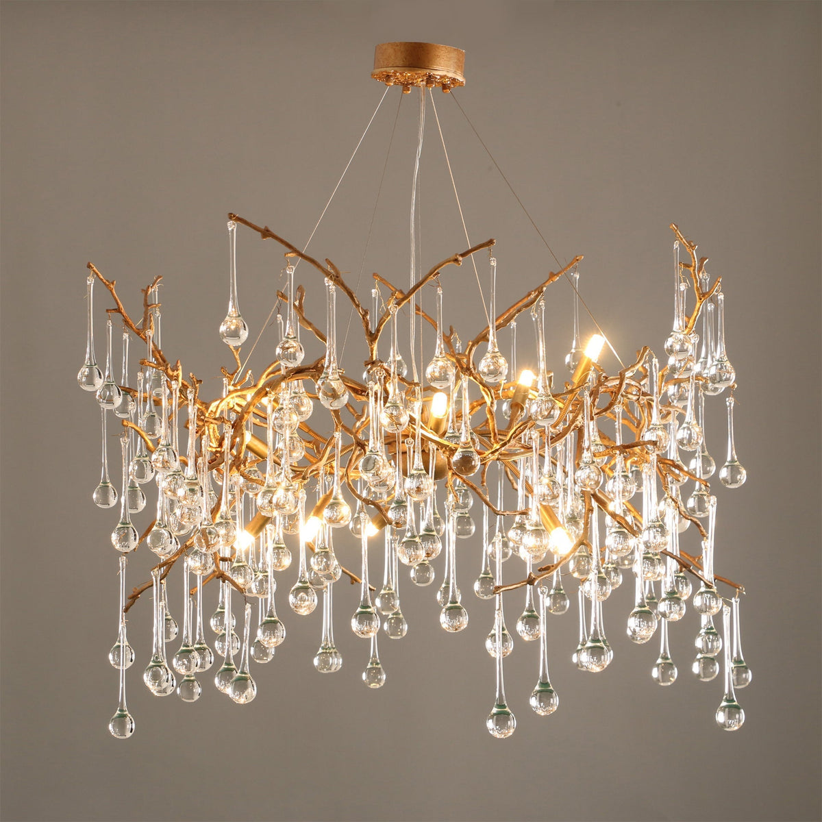 Close-up of the Palwa Chandelier's hand-blown glass droplets on a brass frame.