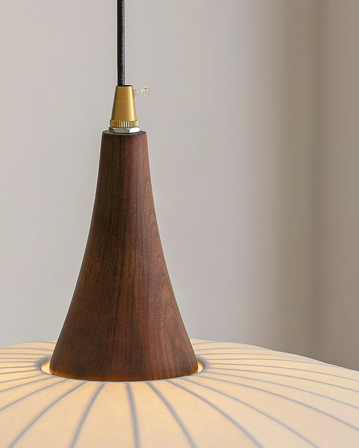 Detail shot of the solid wood base connecting to the fabric shade.
