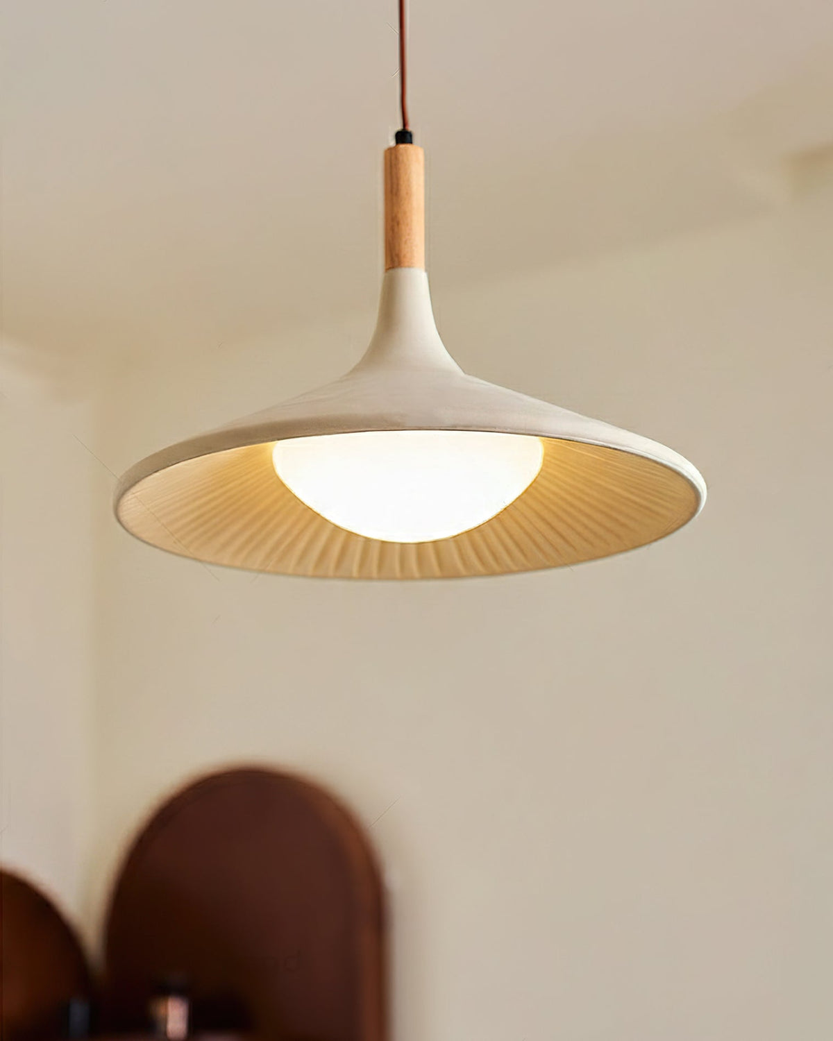 Detail shot of the wooden top and cement shade of the Piero Pendant Lamp.