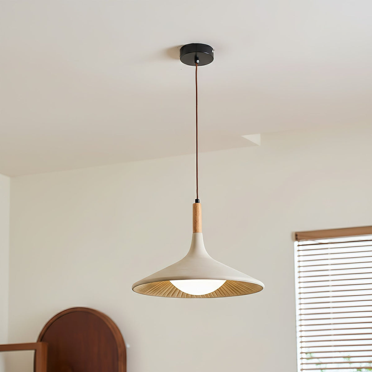 Close-up of the Piero Pendant Lamp showing the texture of the cement and wood.