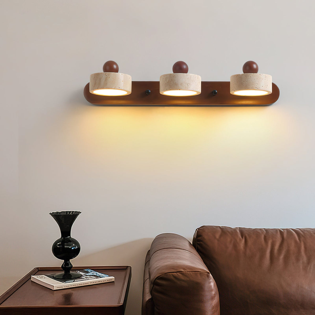 Close-up of the Piero Travertine Wall Lamp showing the stone and wood texture.