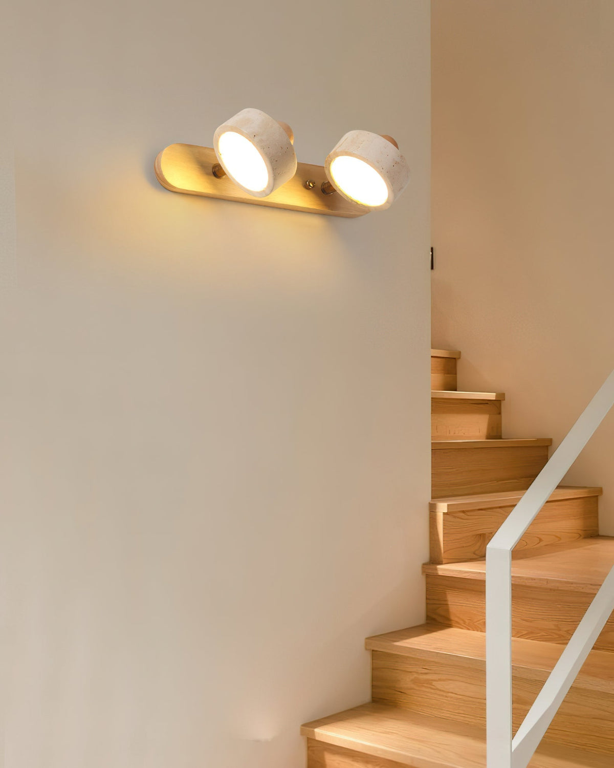 The 4-head version of the Piero Travertine Wall Lamp installed in a modern hallway.
