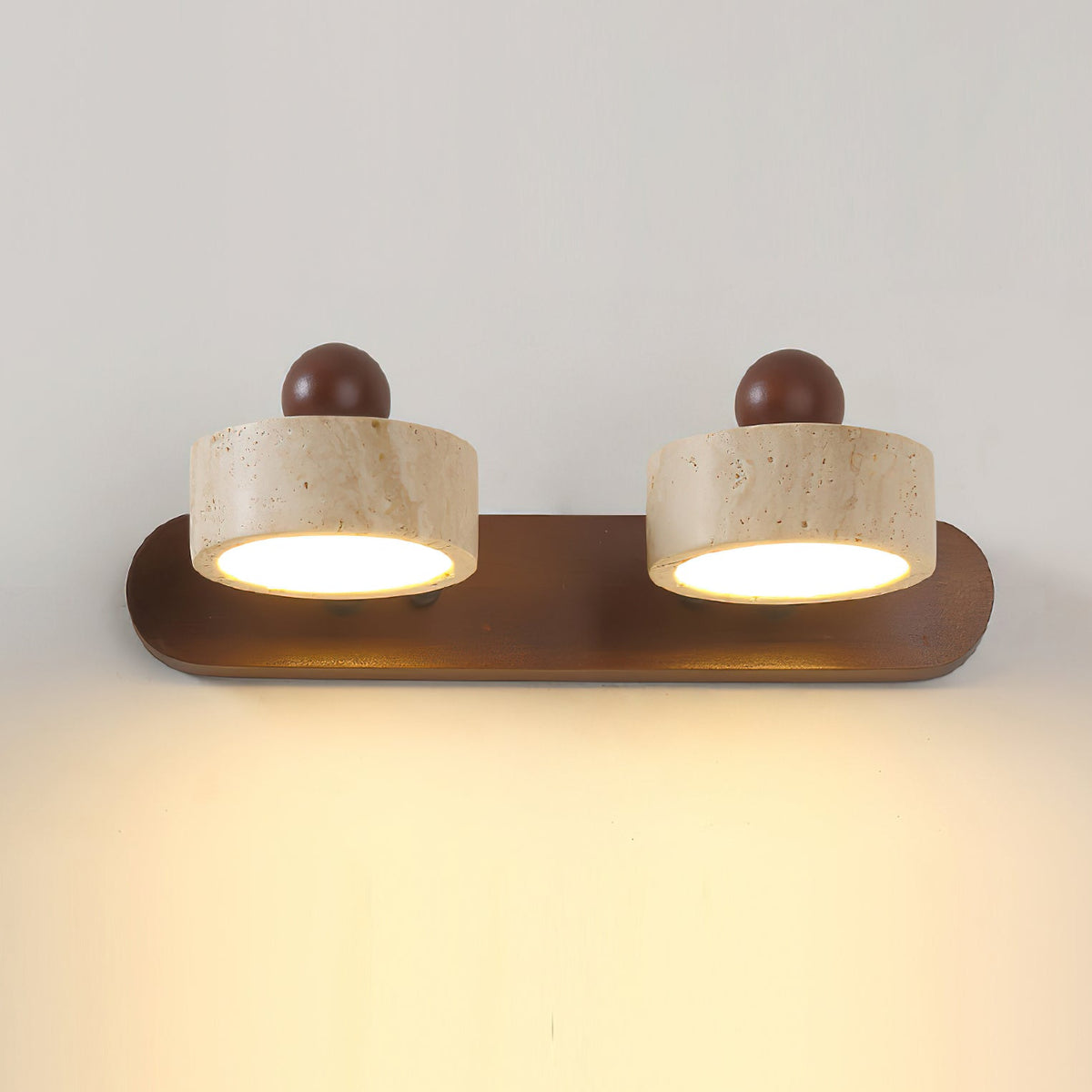 Angled view of the 2-head Piero Travertine Wall Lamp against a plain background.