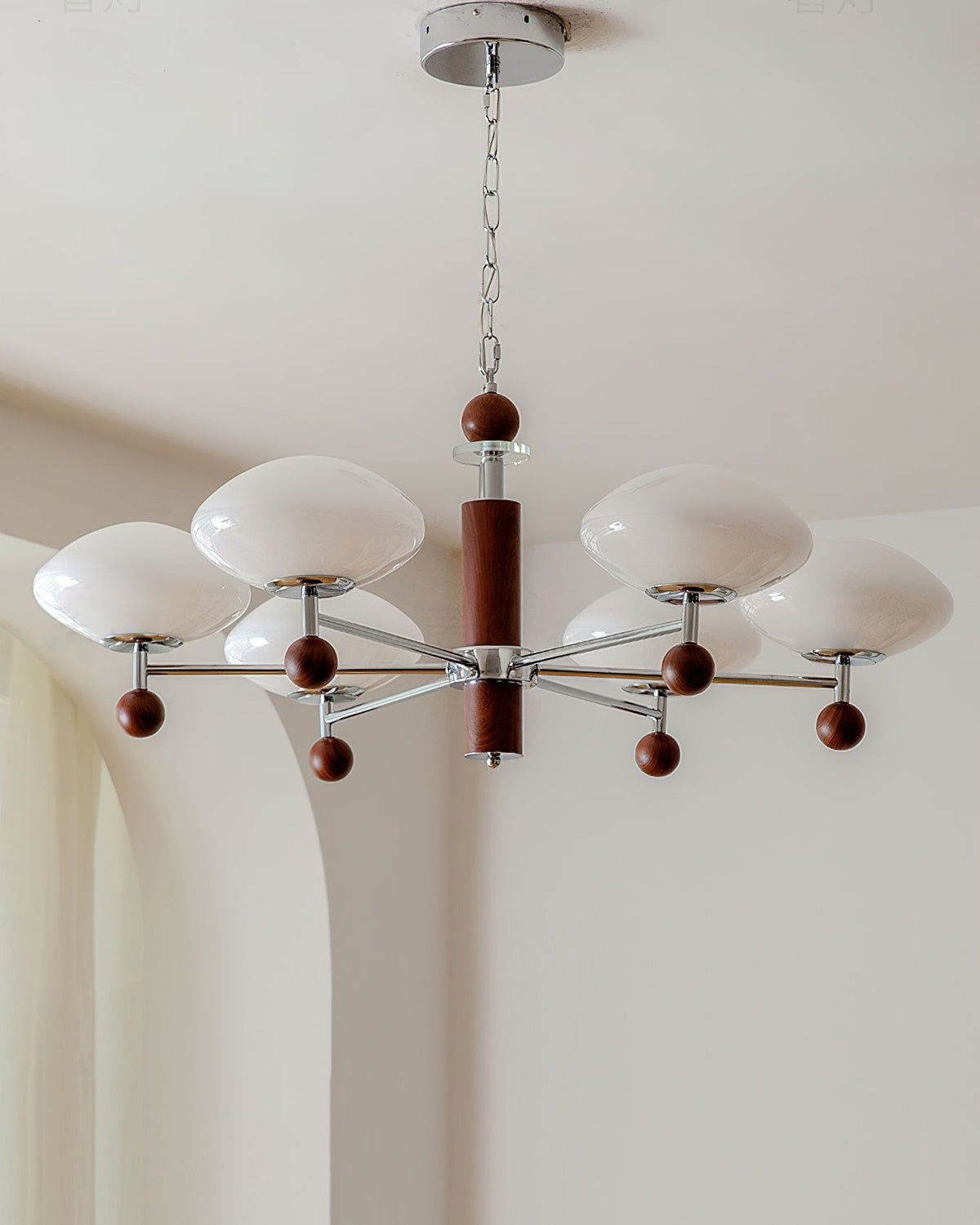 The Pointed Chandelier shown in a dining room above a table.