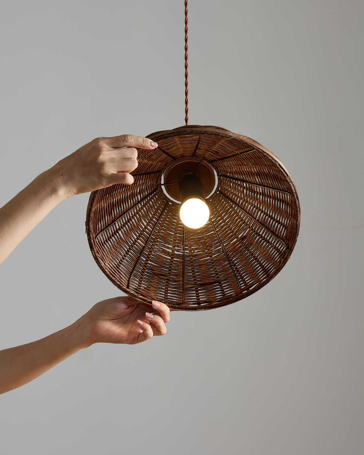 Rasa Pendant Light shown against a plain wall to emphasize its texture.