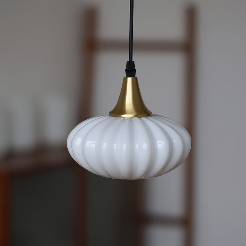 Close-up of the Rayburn Pendant Light's hand-blown glass shade and brass fitting.