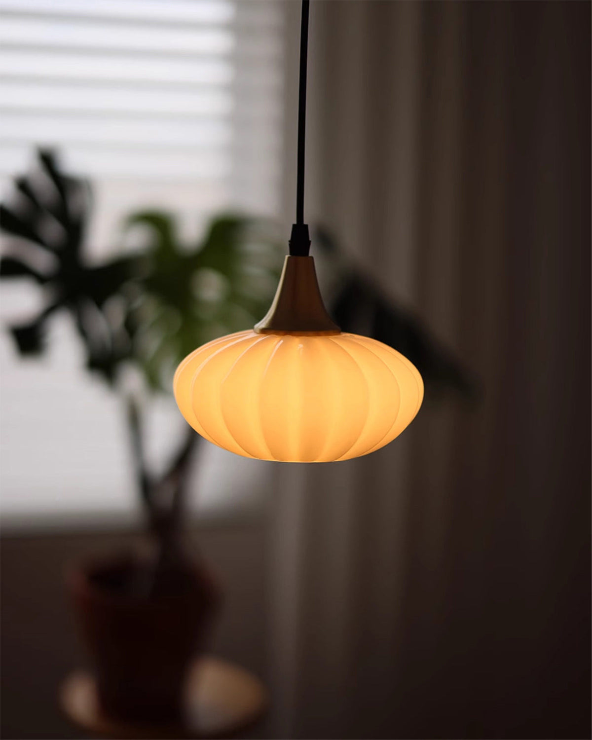 Lifestyle image showing the Rayburn Pendant Light in a bedroom.