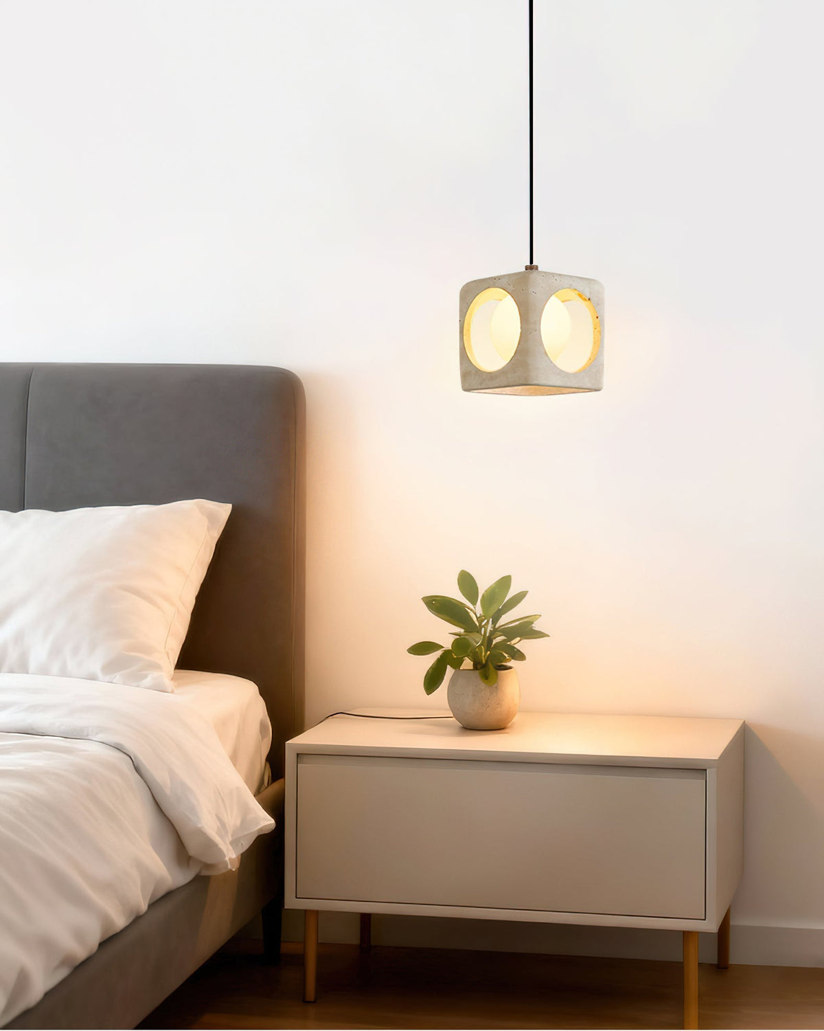 A 3-head cluster of the Remodern pendant lights hanging in a dining area.
