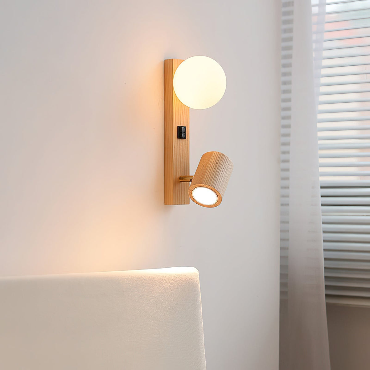 Close-up of the Rensen Wall Lamp's frosted glass globe and wood base.