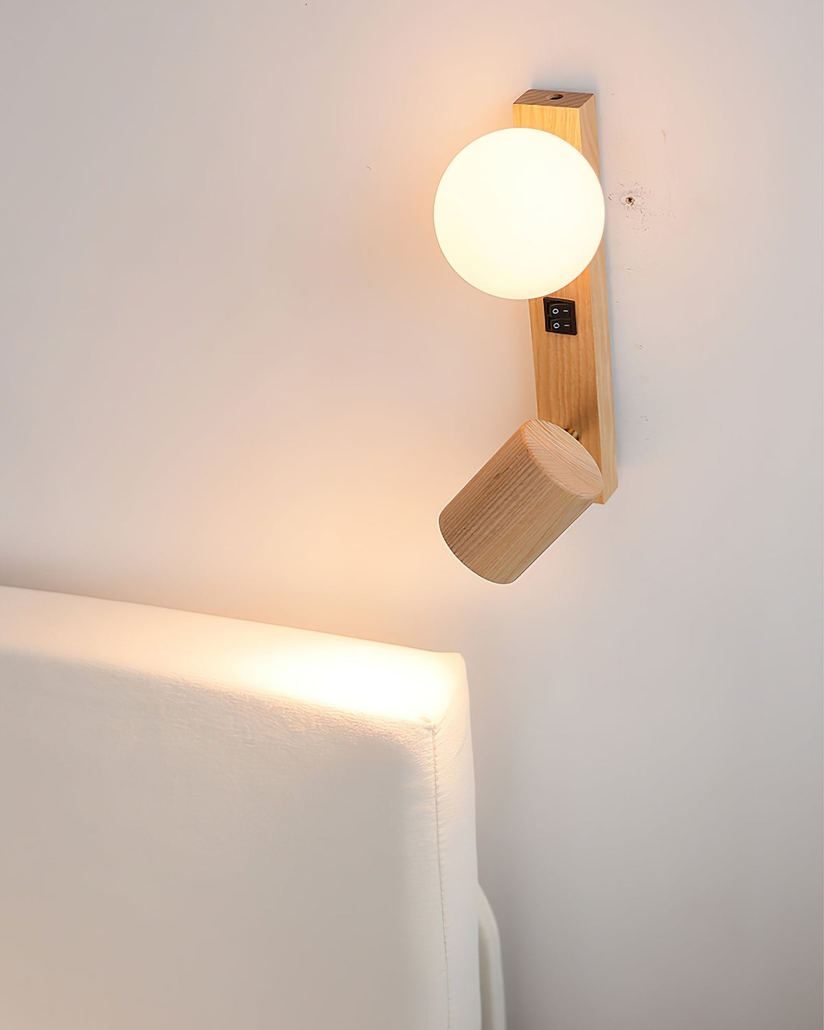 The natural wood grain detail of the Rensen Wall Lamp's fixture.