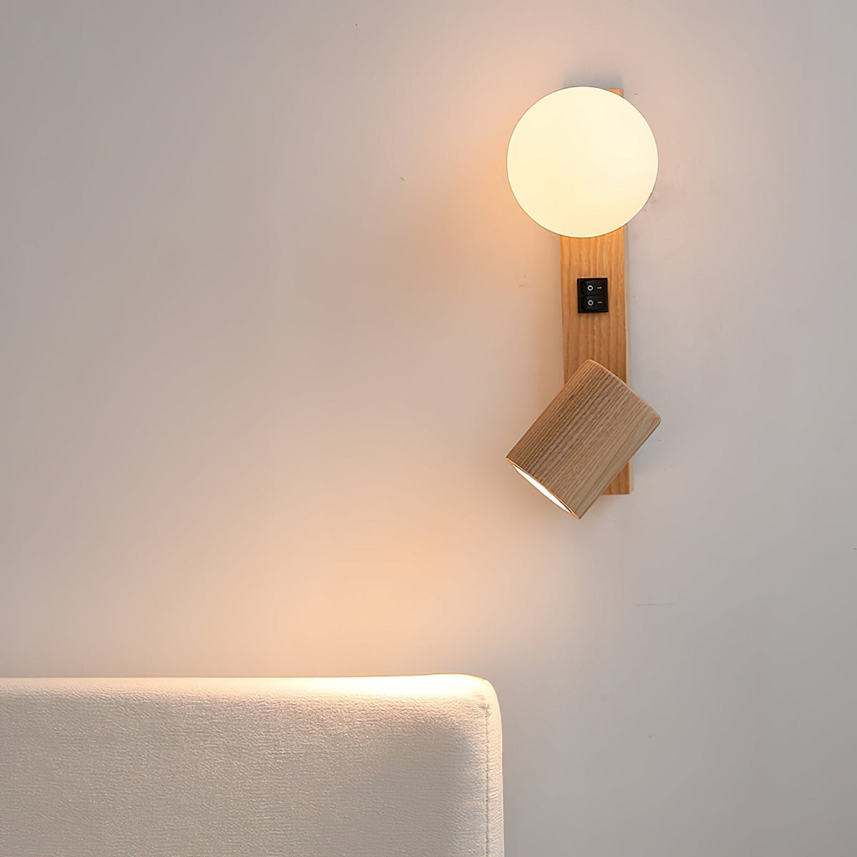 Rensen Wall Lamp with both the globe and spotlight illuminated.