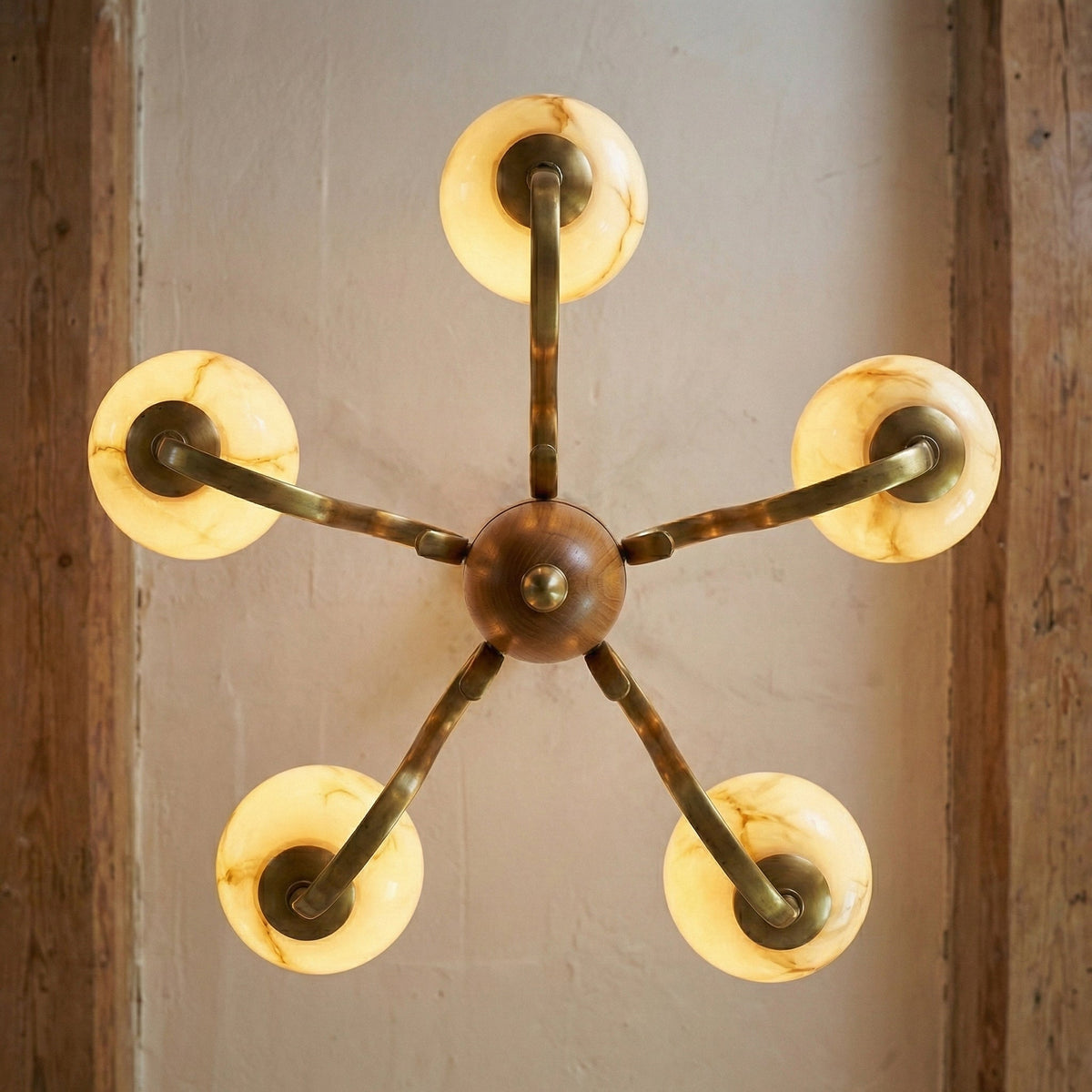 Top-down view showing the sunburst symmetry of the chandelier arms.