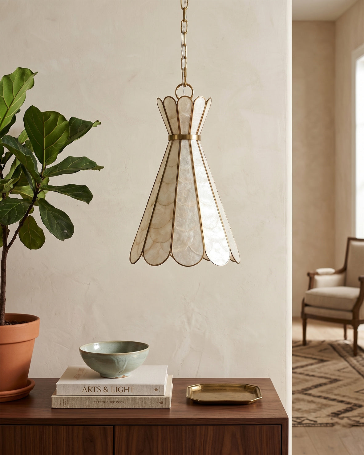 The Rosalind pendant lamp illuminated, showing its warm and soft glow.
