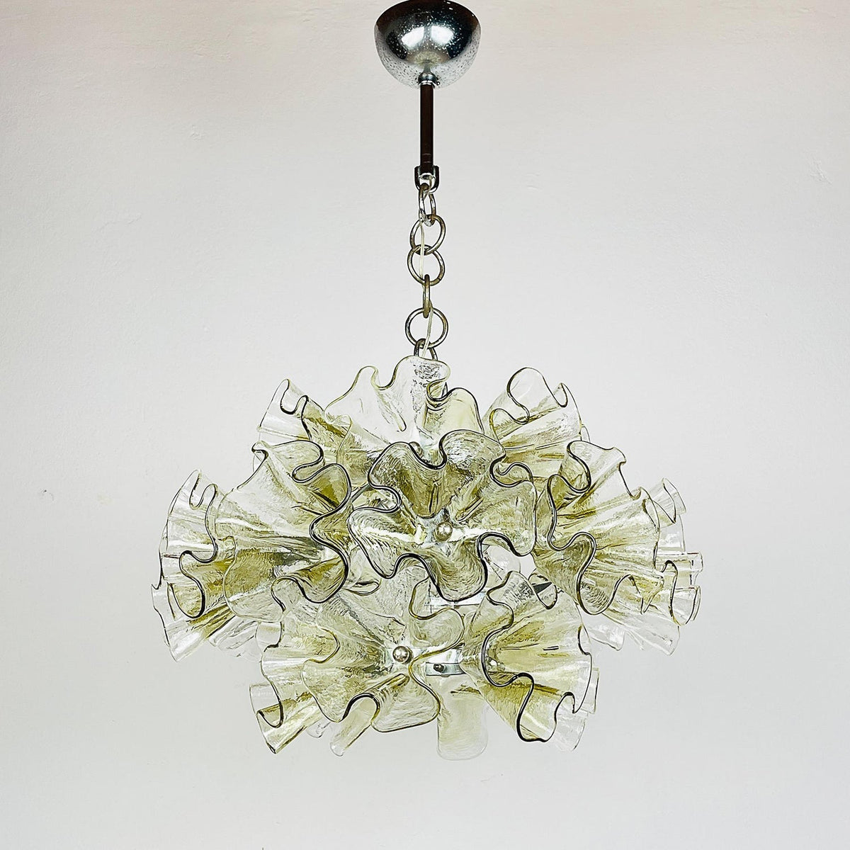 View of the chandelier from below, showing the light cluster.