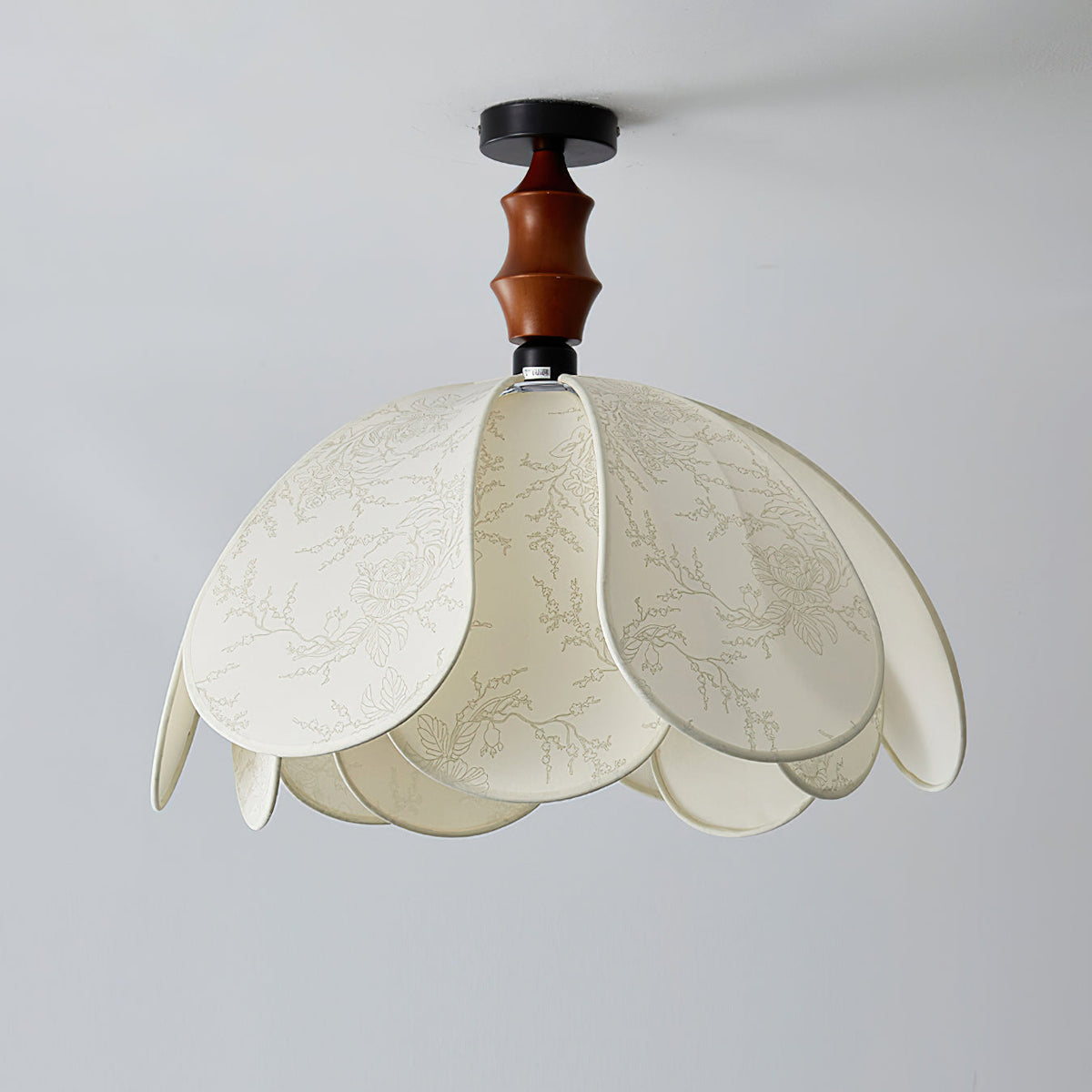 The Savoy Ceiling Light illuminated in a contemporary living room.