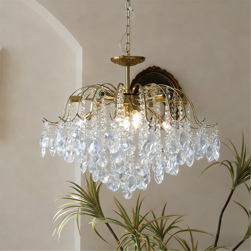 Lifestyle image of the chandelier adding glamour to a bedroom.