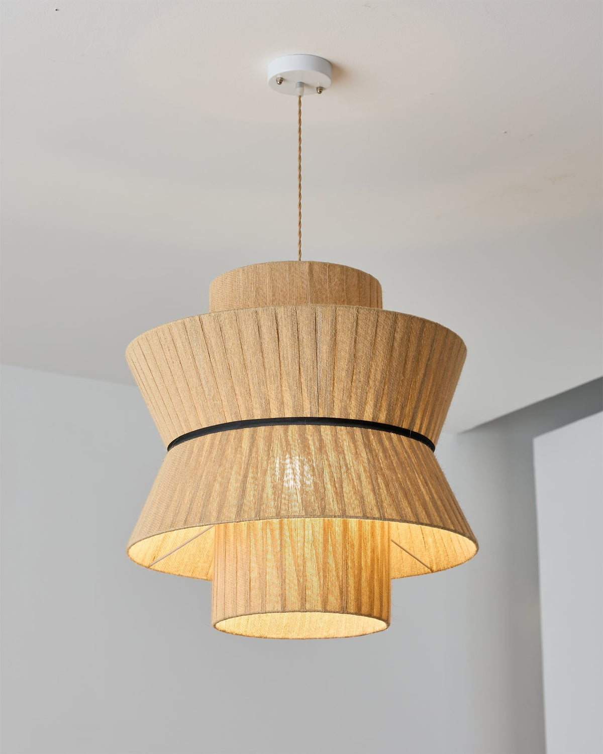 The Sicel Pendant Light against a dark wall, highlighting its texture.