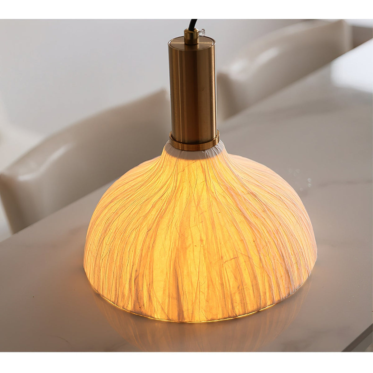The sculptural form of the Siya Pendant Light on a plain background.