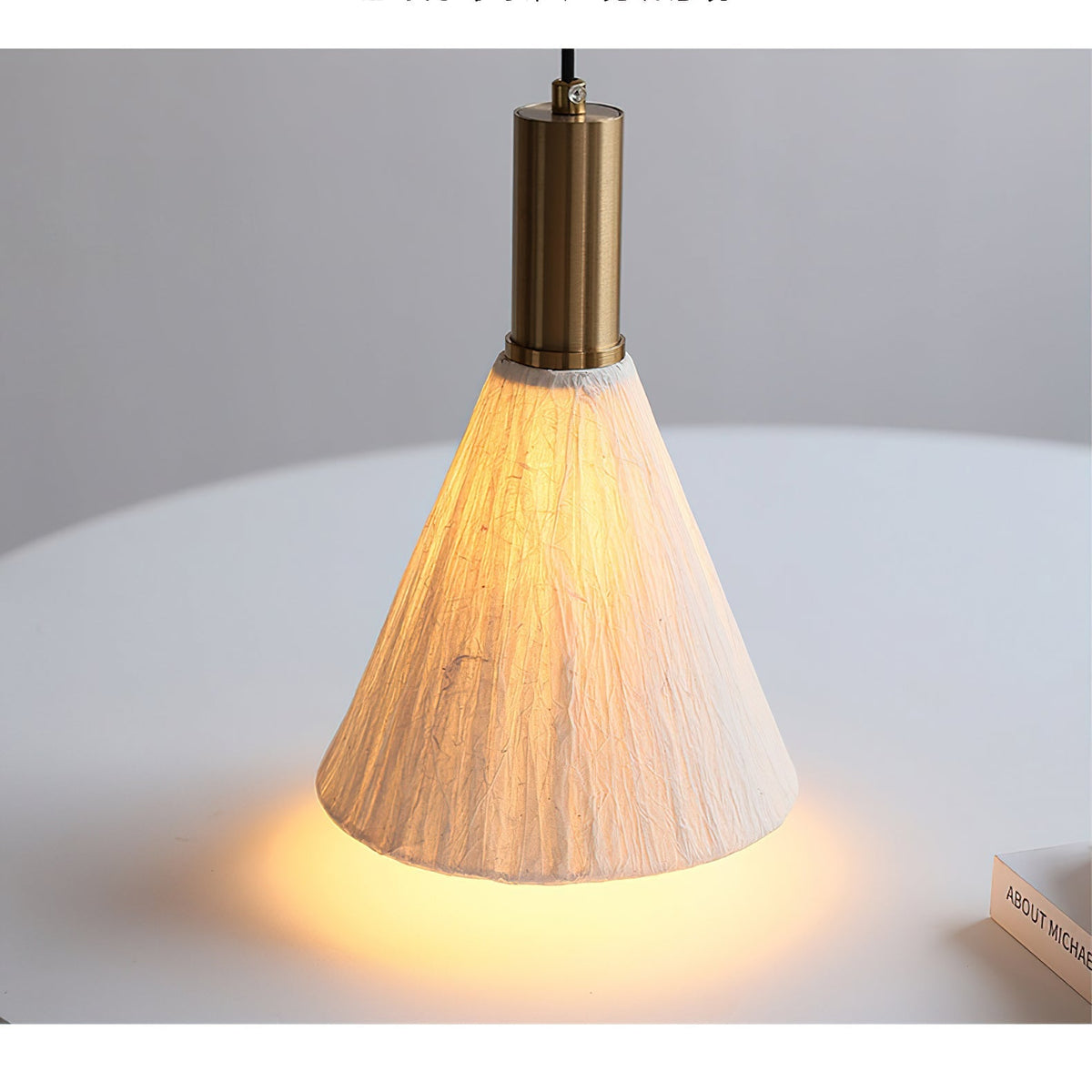Siya Pendant Light shown against a dark wall for dramatic contrast.