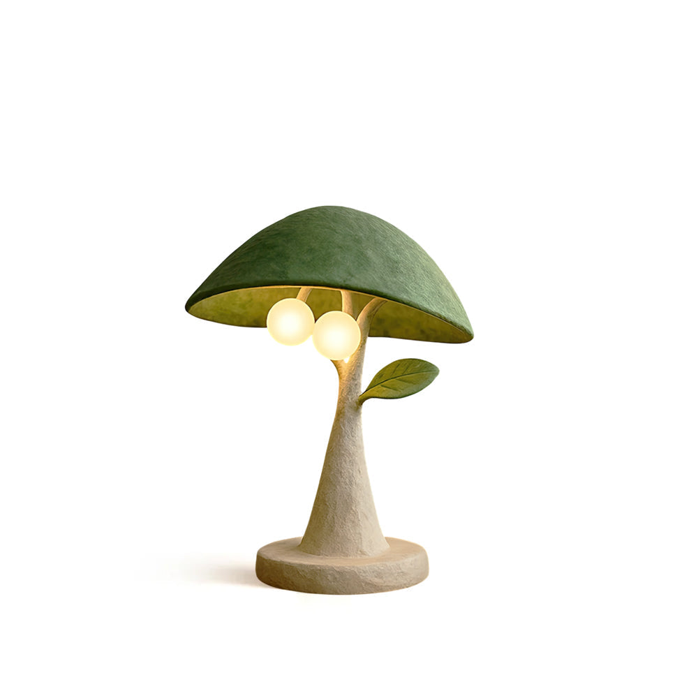 Front view of the Soloma Table Lamp with a green canopy and off-white resin trunk.