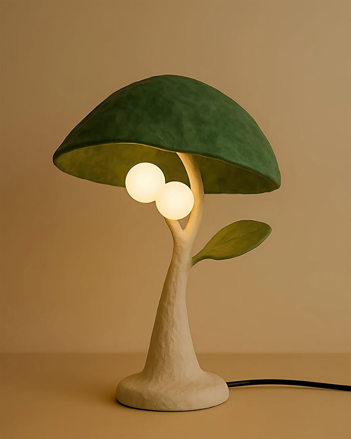 Close-up of the Soloma Table Lamp's two spherical frosted glass diffusers hanging like fruit.