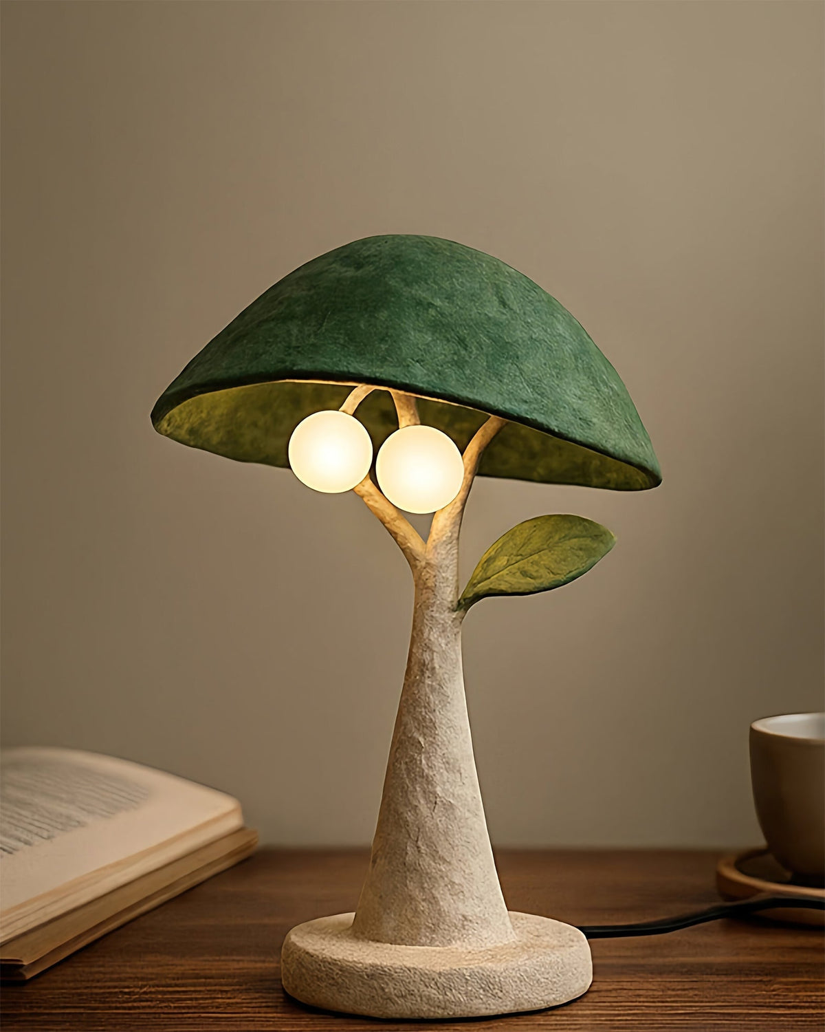 The Soloma Table Lamp shown on a bedside table, casting a warm glow.