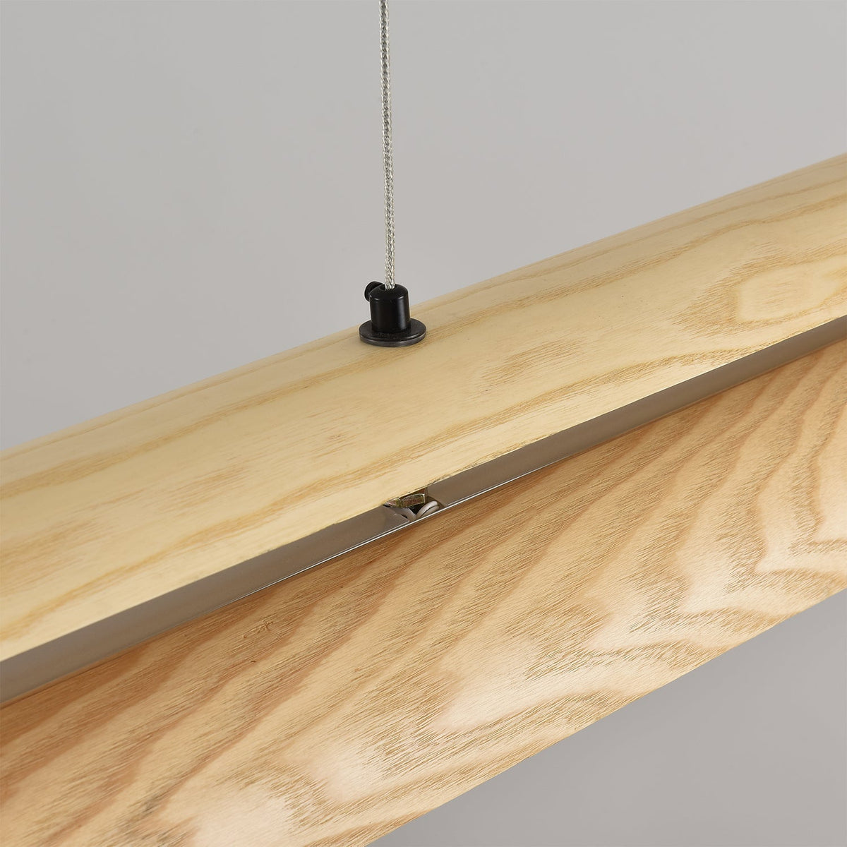 A wide shot of the Sora Linear Chandelier in a spacious living area.