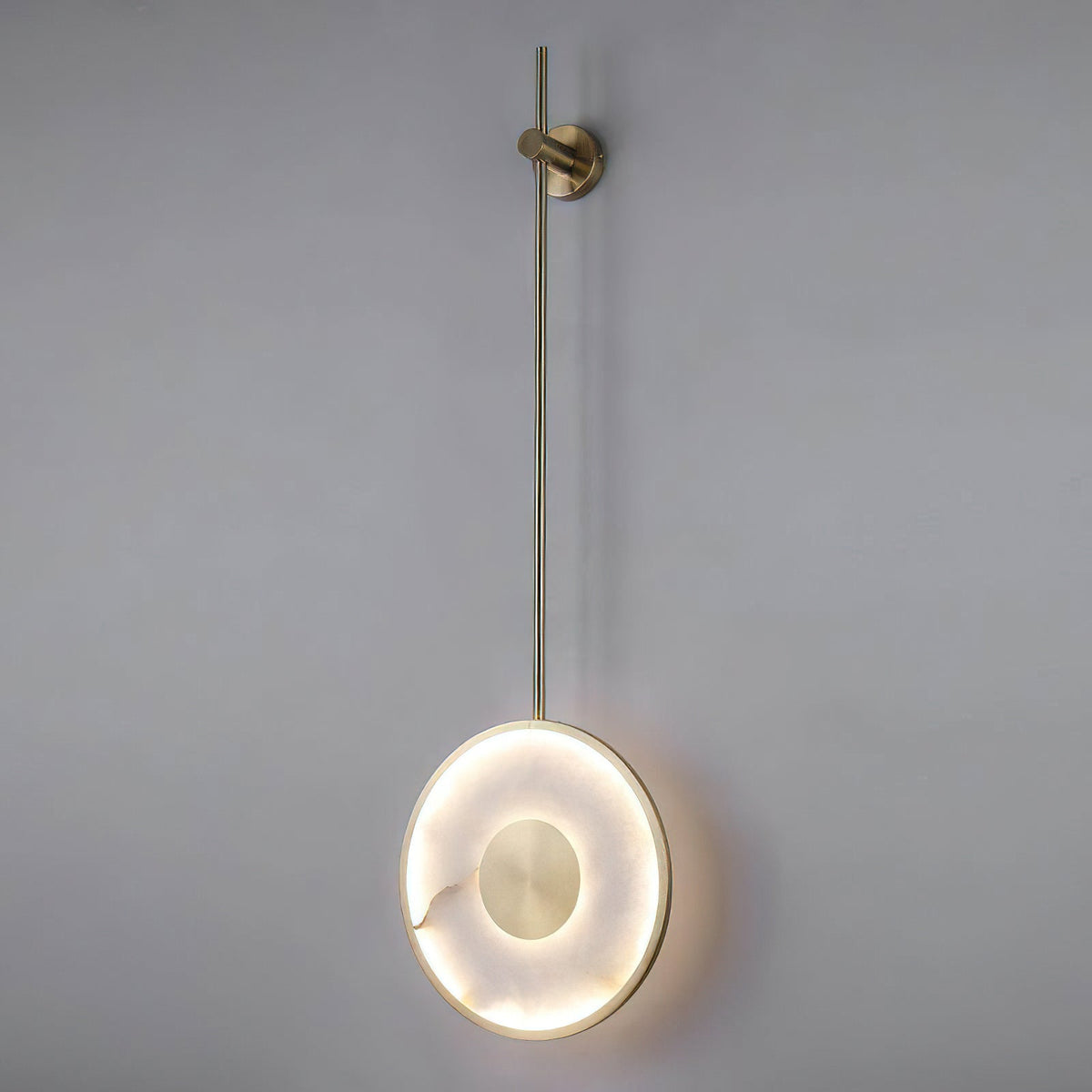 Two Sorle Alabaster Wall Lamps flanking a console table in a hallway.