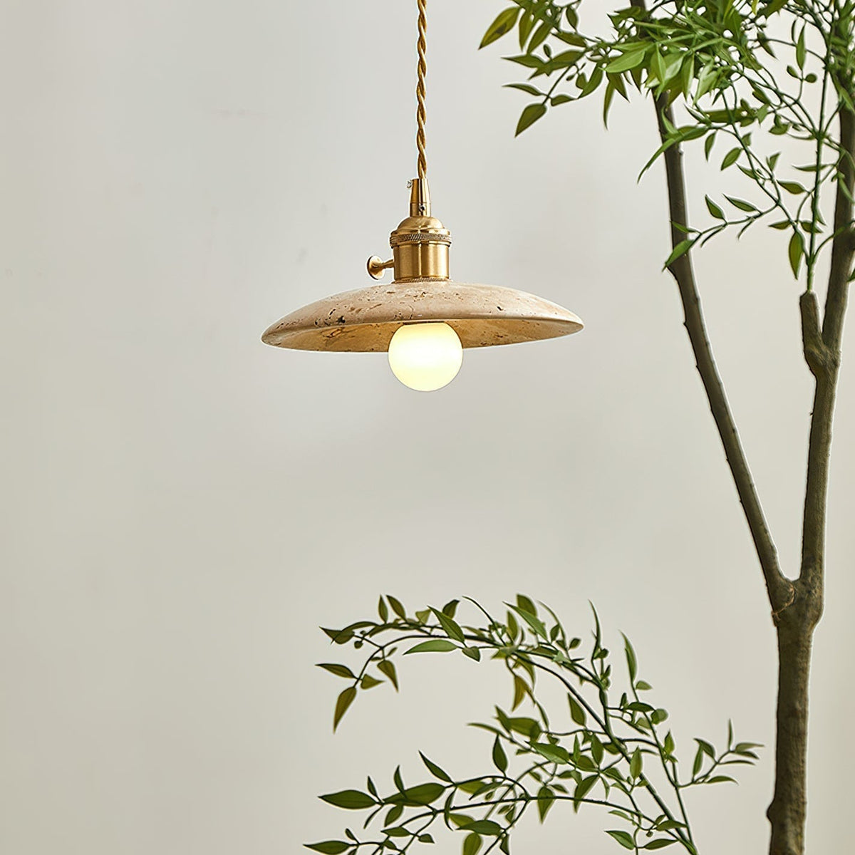 Close-up view of the textured travertine stone on the Stella Pendant Light.