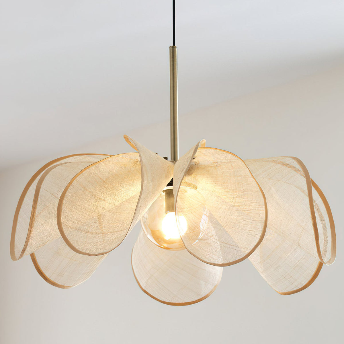 A pair of Styria Petals Pendant Lamps hanging over a dining table.