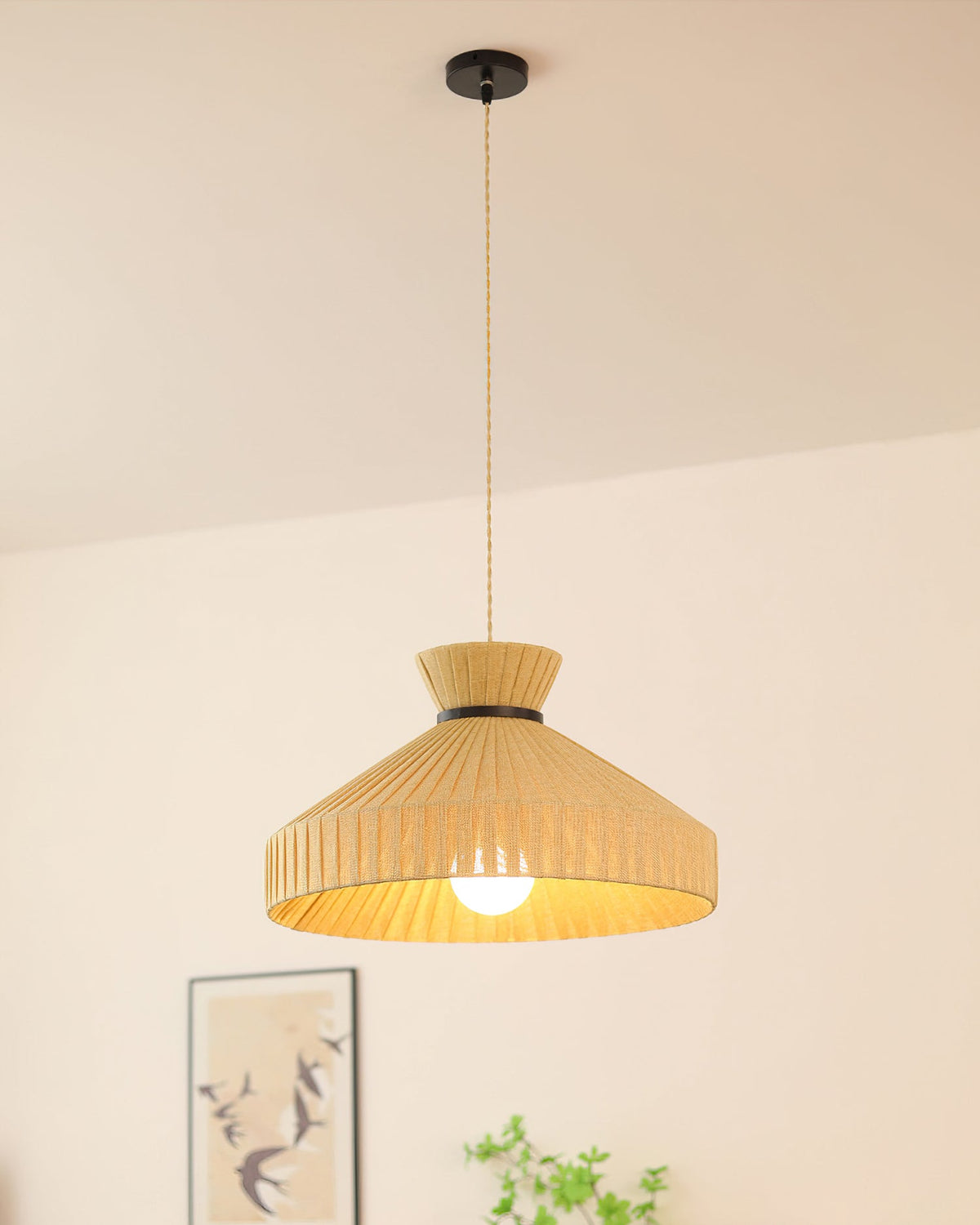 The smallest size of the Surora Pendant Light used in a bedroom.